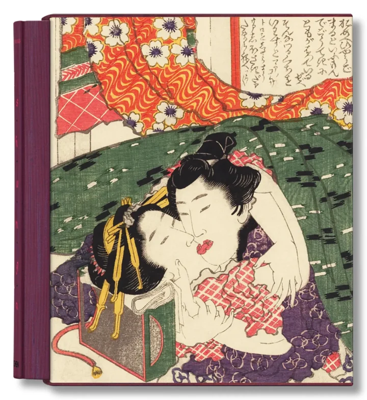 Two lovers in an intimate embrace in a Japanese ukiyo-e woodblock print by Hokusai, featuring vibrant kimonos and traditional hairstyles.