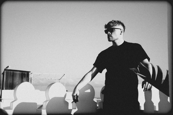 Davide Edoardo on a rooftop in Tangier wearing sunglasses, black and white photograph